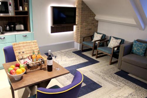a living room with a table and chairs and a television at 91 Aparthotel Jesmond Road in Newcastle upon Tyne