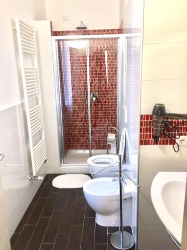 a bathroom with a shower and a toilet and a sink at B&B Bruna in Florence