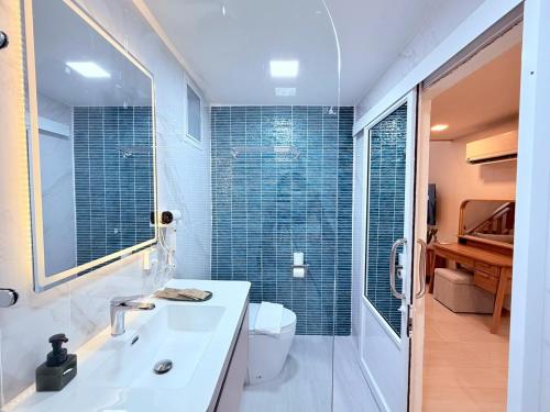 a bathroom with a sink and a shower and a toilet at Lanta Forest Resort & Villas in Ko Lanta Yai