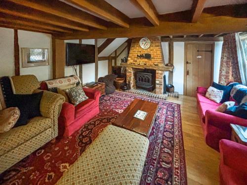 a living room with two couches and a fireplace at Rumbolds Retreat in Plaistow