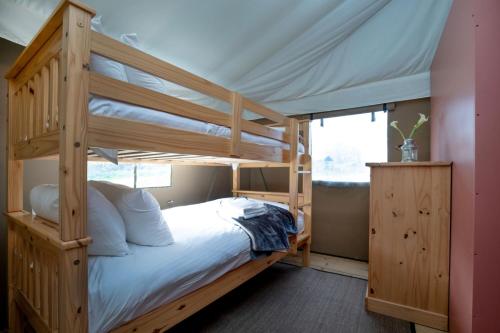 a bedroom with a bunk bed with a ladder at Kestrel - Sweffling Hall in Rendham