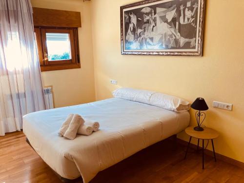 a bedroom with a bed with two towels on it at Fuenteberros 1 in Golmayo