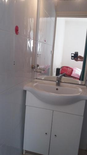 une salle de bain avec un lavabo blanc et un miroir dans l'établissement CANET Plage appartement vue latérale mer, 1 chambre , WIFI, climatisation, parking sécurisé couvert, à Canet