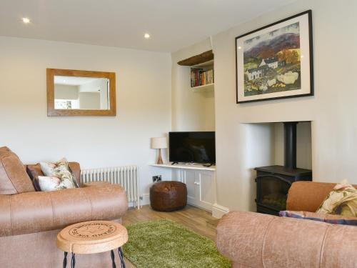 a living room with two couches and a fireplace at Rooftops - Uk34065 in Grassington