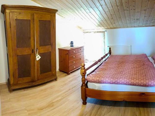 a bedroom with a bed and a dresser in a room at Ferienwohnung Ruf in Küps