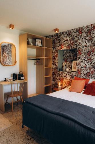 a bedroom with a bed and a desk in it at Domaine Etxezahar in Bardos