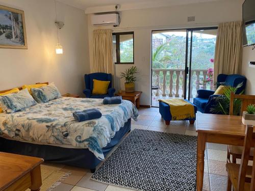 a bedroom with a bed and a table and chairs at Crayfish Inn no6 in Ramsgate