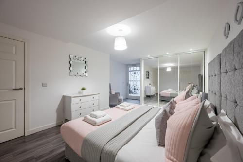 a bedroom with a large bed and a mirror at Casa Fresa - King Street Apartments in Dundee