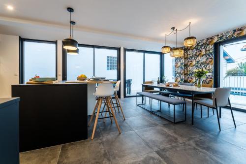 a kitchen and dining room with a table and chairs at BLOOMY - Villa Biarritz in Biarritz
