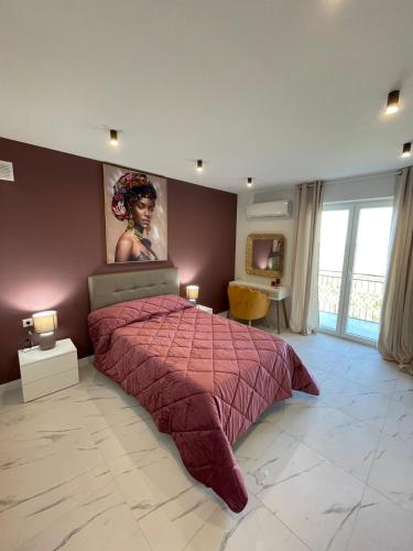 a bedroom with a bed with a painting on the wall at Nela in Carini
