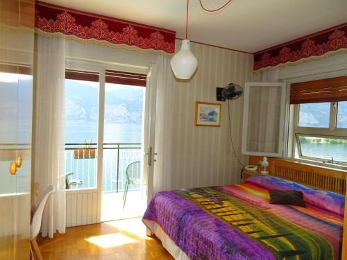 a bedroom with a bed and a balcony at Casa Alessandra in Malcesine