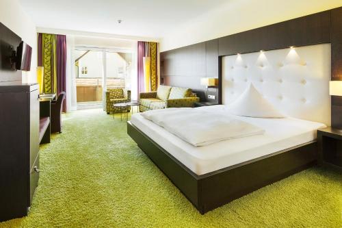 a bedroom with a large bed in a room at Hotel Sonne Rudersberg in Rudersberg