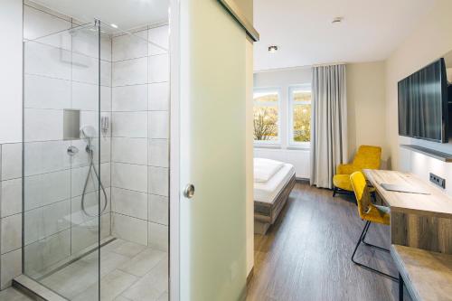 a bathroom with a shower and a sink at Hotel Sonne Rudersberg in Rudersberg