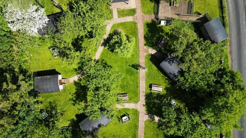 an overhead view of a yard with trees and buildings at Orchard Hideaways, Penrith, The Lake District in Penrith