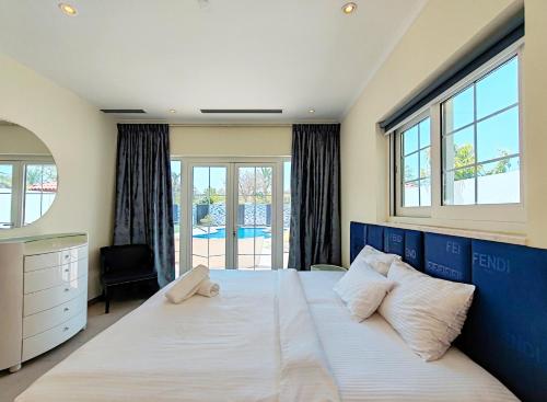 a bedroom with a large bed with a large window at Royal Palazzo with private Pool and BBQ on Marina, huge 7Bedroom Villa in Dubai