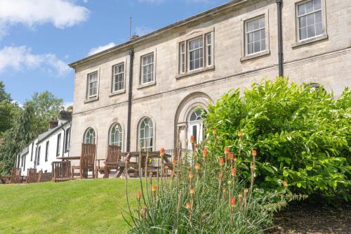 a building with a table and chairs in front of it at Waterfoot Park in Pooley Bridge