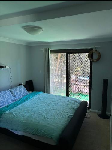 a bedroom with a bed and a large window at Hidden Gem North Sydney in Sydney