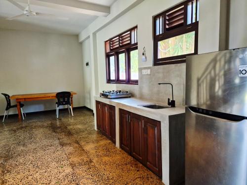 a kitchen with a sink and a counter top at Lake view Oasis Koggala in Malalagamaduwa