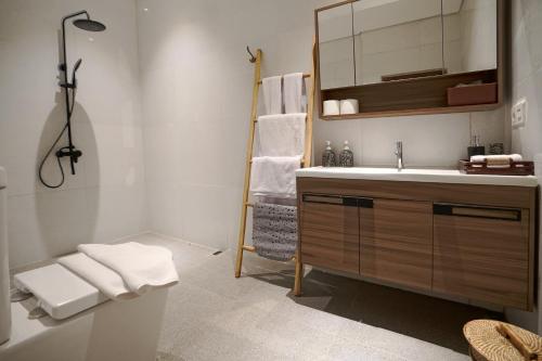 a bathroom with a sink and a mirror at Juan Villa Legian in Seminyak