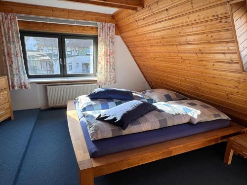 a bedroom with a bed in a wooden room at Ferienhaus Winkelwerk in Goslar