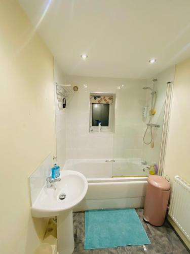 a bathroom with a sink and a tub and a toilet at Stay with LL in Doncaster