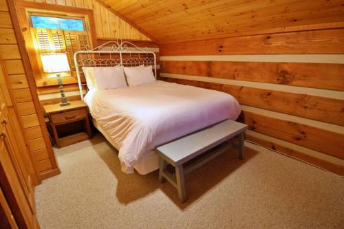 a bedroom with a bed in a log cabin at The Cove in Canton