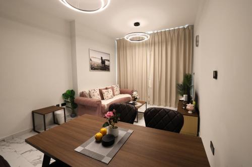 a living room with a table and a couch at 1 Bedroom 1 Min walking to Cleveland and Galleria Mall by Central Stay in Abu Dhabi