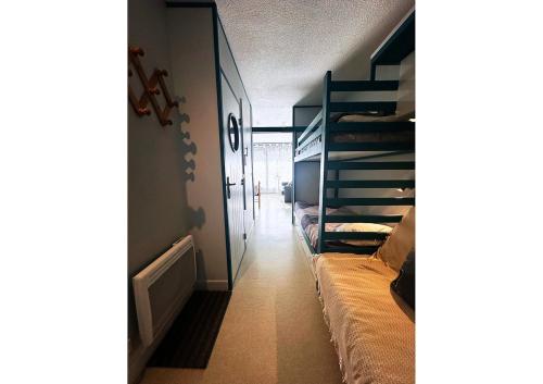 a room with two bunk beds and a hallway at Studio Anouk 4 personnes à Laruns in Laruns
