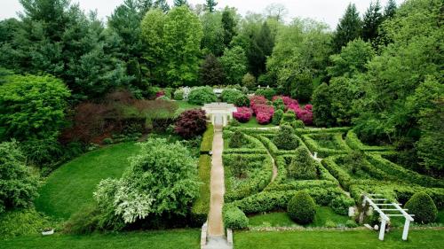 an aerial view of a garden with bushes and trees at Airlie in Warrenton