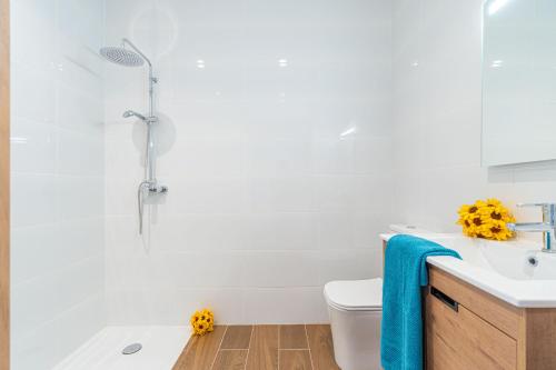 a white bathroom with a sink and a shower at Jouvacations Villa Osona in Vilafant