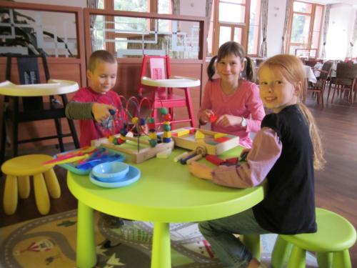 a group of children playing with a toy table at Wellness Resort Energetic in Rožnov pod Radhoštěm