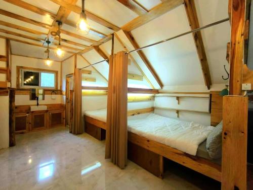 a bedroom with a large wooden bed in a room at Lolo Dads Cabin in Sagada