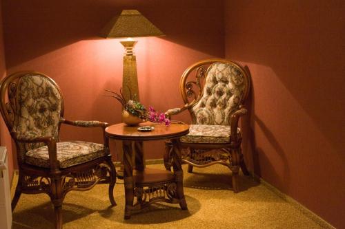 a room with two chairs and a table and a lamp at Hotel Complex Zelenyi Gai in Kopachuvka