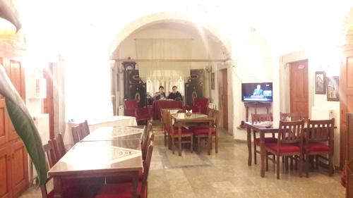 a group of people sitting at tables in a restaurant at Demirkapi Konak Hotel in Safranbolu