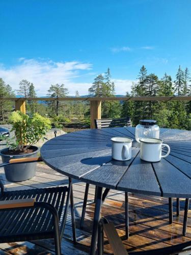 a blue table with two mugs on top of it at Modern Cabin At Blefjell in Svene