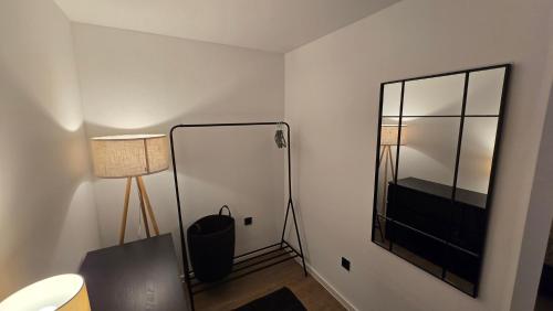 a room with a mirror and a desk with a lamp at Kleine Austernperle in Dornumersiel