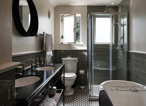 a bathroom with two sinks and a toilet and a shower at The Grandtully Hotel in Grandtully
