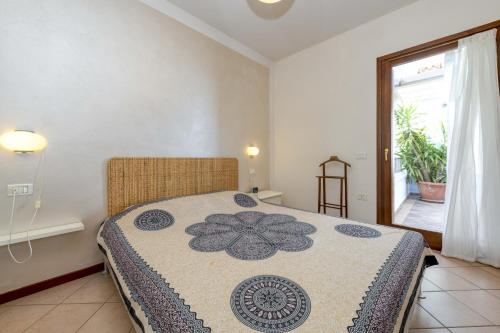 a bedroom with a bed with a flower on it at Villa Bella by Garda FeWo in Manerba del Garda