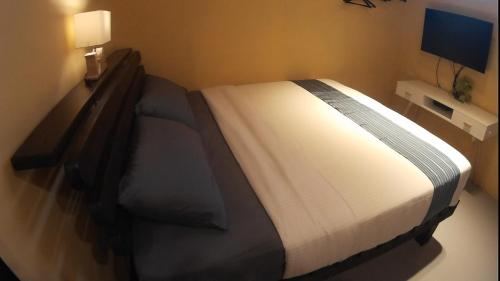 a bed in a room with a large bed sidx sidx sidx at On Board Hostel in Manzhou
