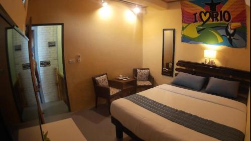 a bedroom with a bed and a bathroom with a shower at On Board Hostel in Manzhou