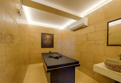 a bathroom with a black counter and a sink at Hotel Chenthur Park in Coimbatore