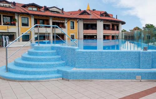 a set of blue stairs leading to a swimming pool at Cozy Apartment In Grado in Grado