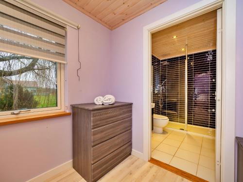 a bathroom with a toilet and a window at Finest Retreats - Oasis 41 in Fritton