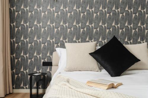 a bedroom with a bed with a book on it at Corner Residence by GoodMove - Casablanca in Casablanca