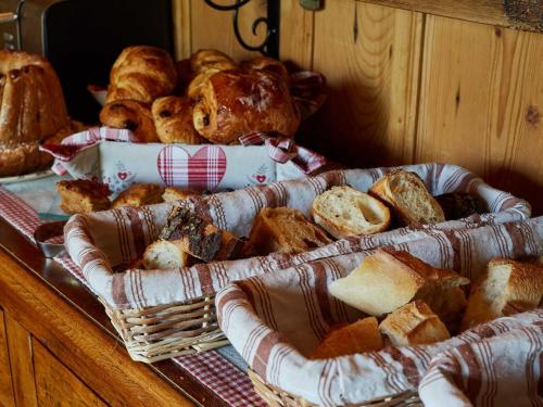 a basket of bread and pastries on a table at Les Prés D'ondine in Sélestat