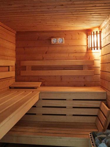 a wooden sauna with a bench in the middle at Les Prés D'ondine in Sélestat