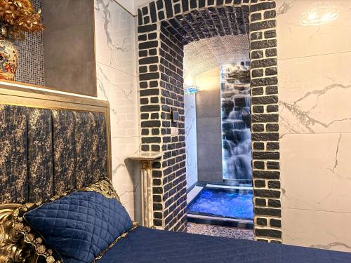 a room with a shower with a blue pillow on a bed at SPA Hotel Liliova Prague Old Town in Prague