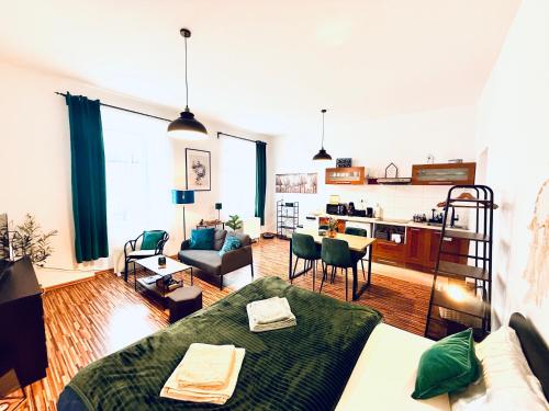 a living room with a couch and a living room with a kitchen at Apartmán na Žerotínce in Šumperk