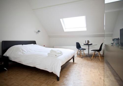 a bedroom with a bed and a table and chairs at B&B Yellow Submarine in Antwerp