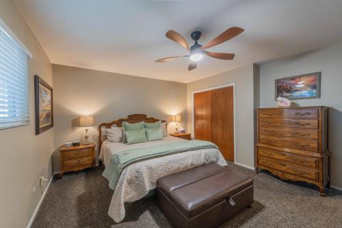 a bedroom with a bed and a ceiling fan at Beach Bum Retreat in Cayucos